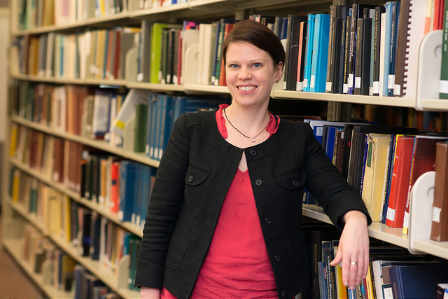 Elise Ferer stands in front of the stacks in the W. W. Hagerty Library